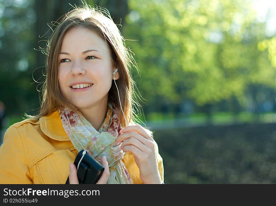 Young woman walking and listnening music. Young woman walking and listnening music