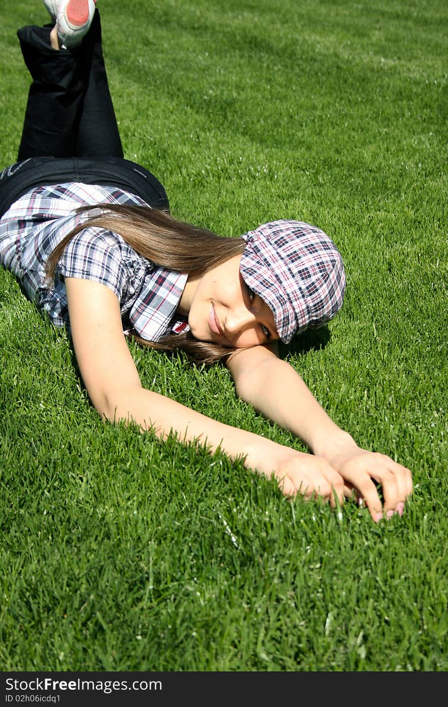 Pretty Girl Relaxing On The Grass