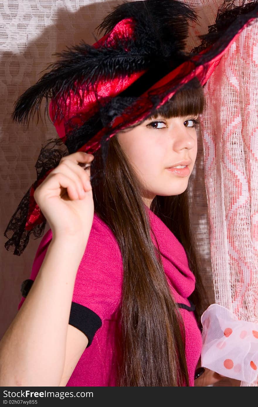 Lovely teen girl in pink dress and hat