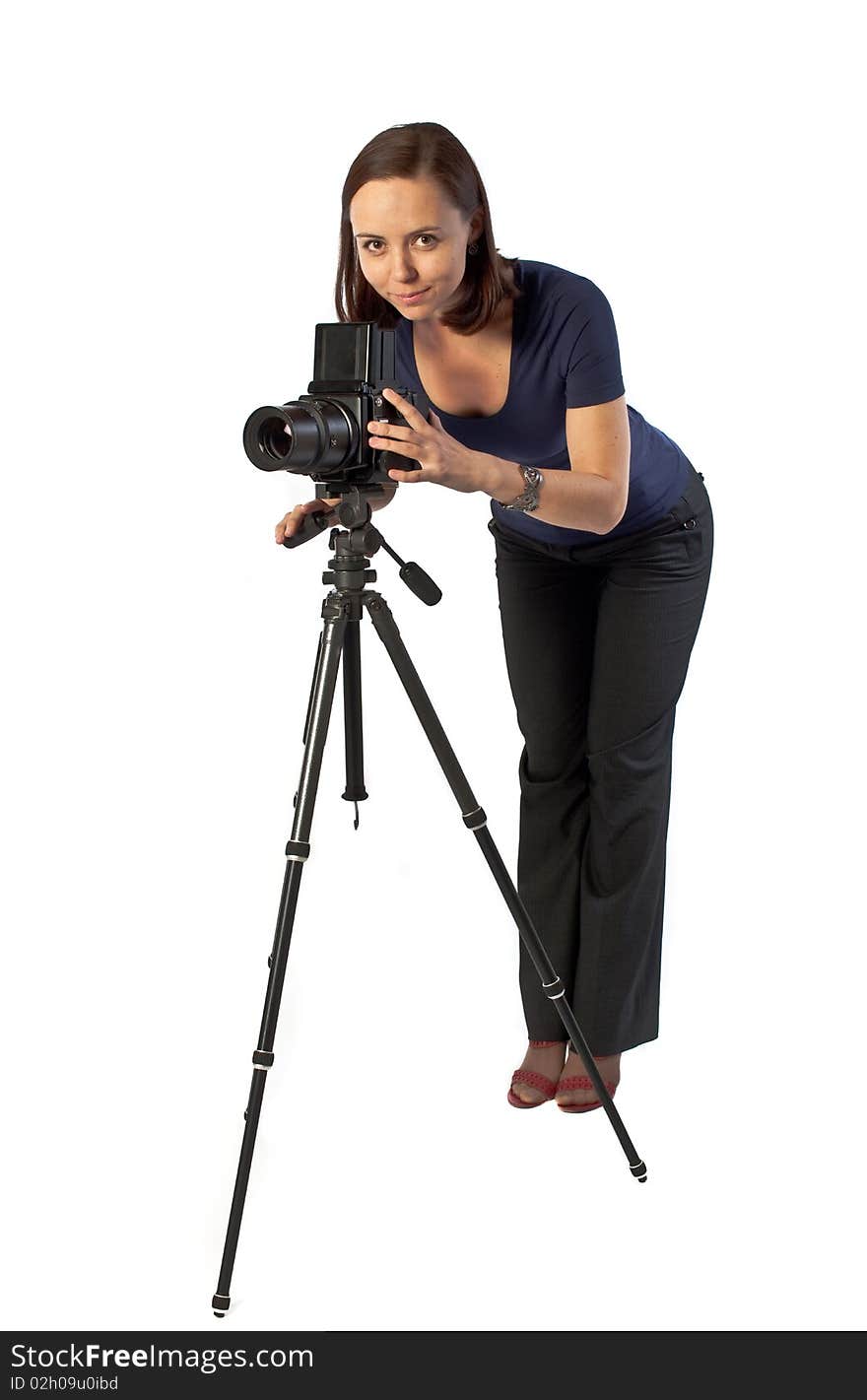 Photo of beautiful girl working with big camera mounted on tripod. Isolation on the white. Photo of beautiful girl working with big camera mounted on tripod. Isolation on the white