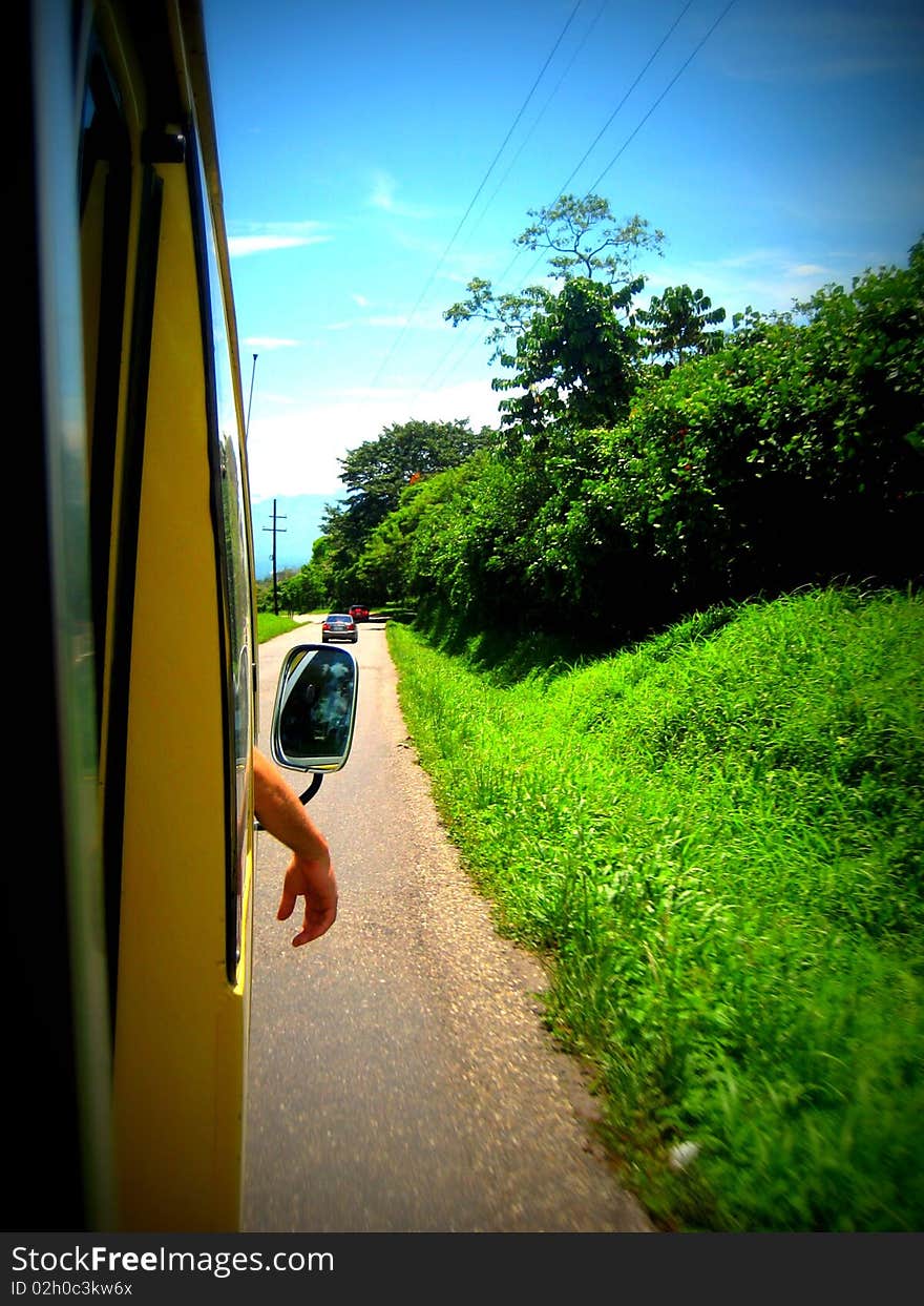 Arm hanging out of bus window with pretty background. Arm hanging out of bus window with pretty background