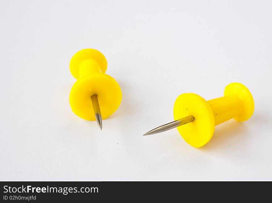 Two pushpins on white background