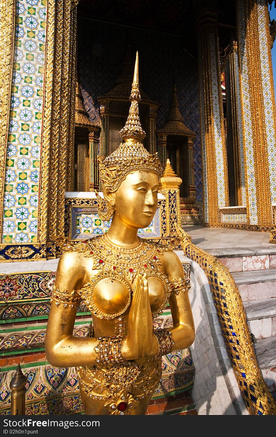 A kinaree, a mythology figure, is watching the temple in the Grand Palace. A kinaree, a mythology figure, is watching the temple in the Grand Palace