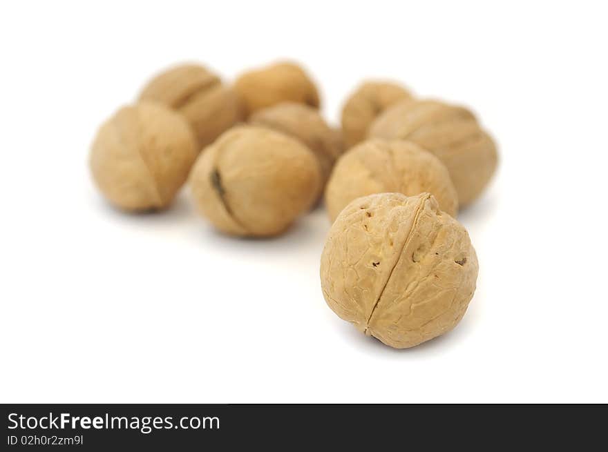 A pile of walnuts isolated on a white background