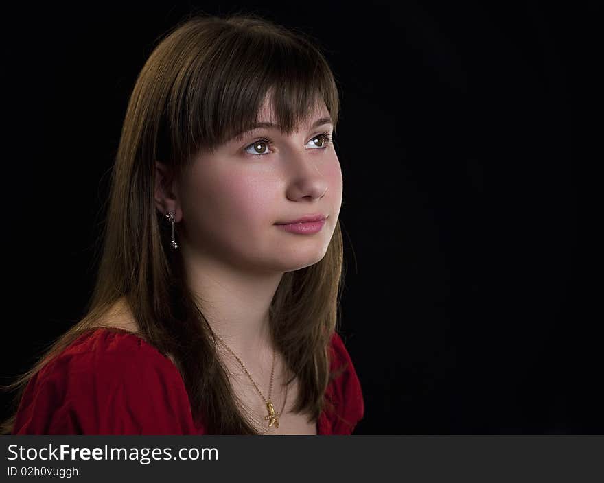 Beautiful girl looking away on a black background. Beautiful girl looking away on a black background