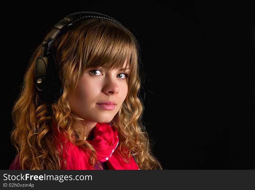 Beautiful young lady with headphones on a blue background. Beautiful young lady with headphones on a blue background