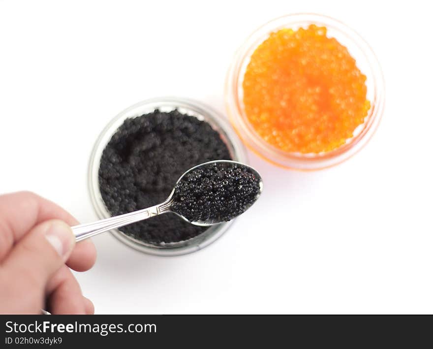 Human hand holding a spoon with black caviar. Human hand holding a spoon with black caviar