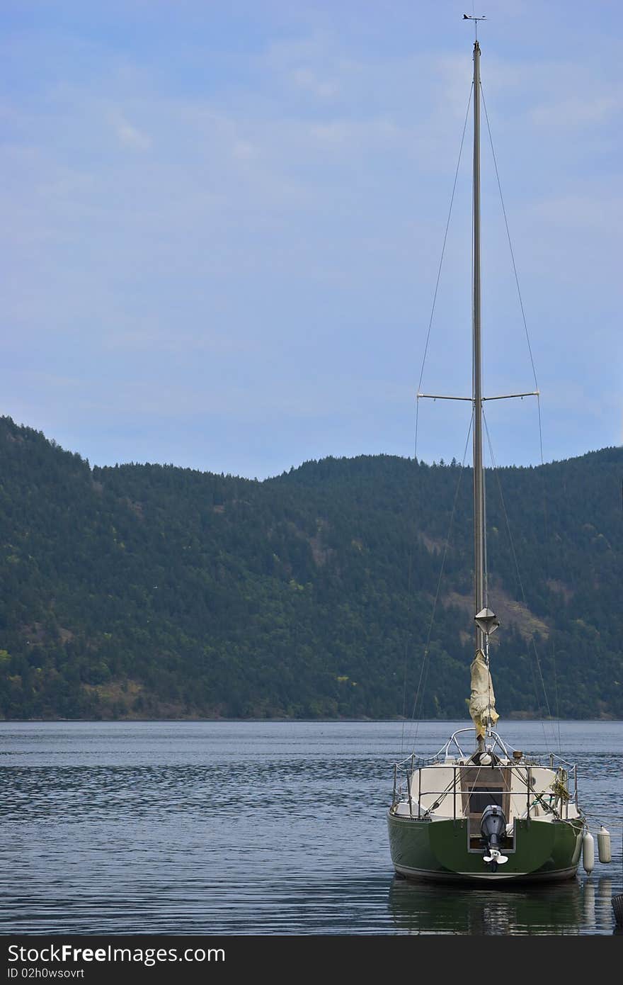 Green Sailboat On Calm Water