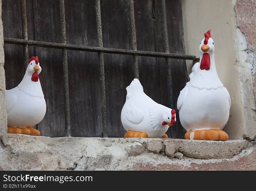 Craft chickens in a window with iron. Craft chickens in a window with iron