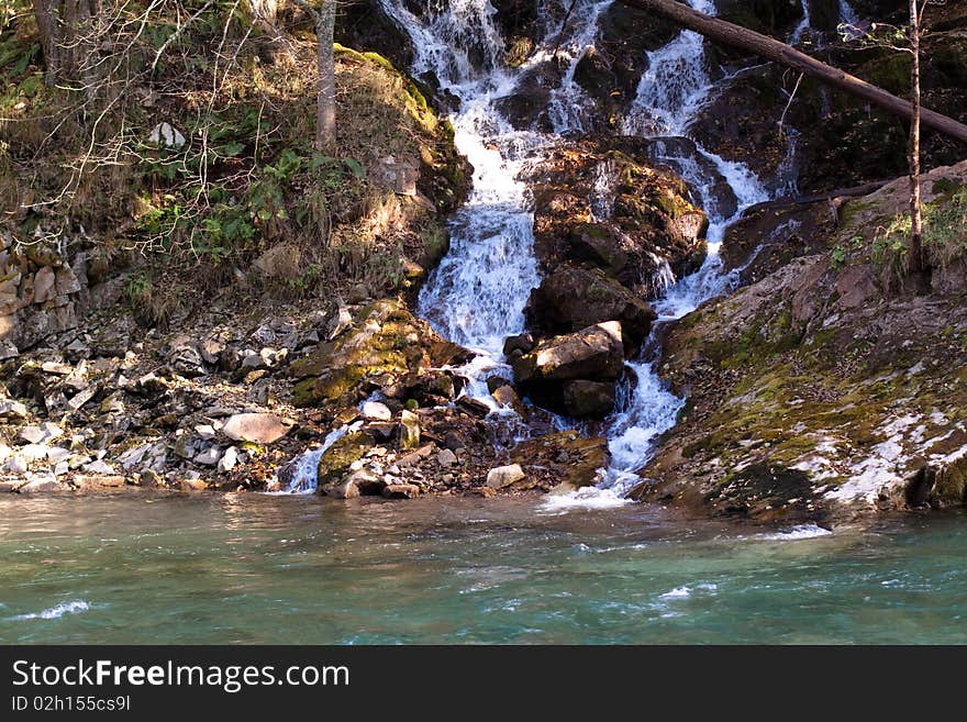 Small waterfall, trees and river