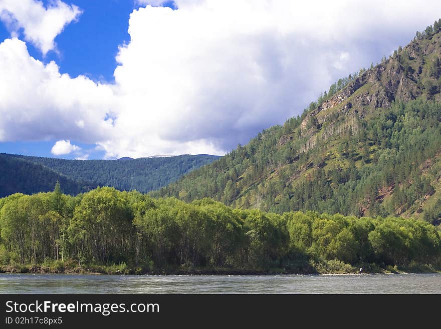 Mountain panorama: sky, forest and river. Mountain panorama: sky, forest and river