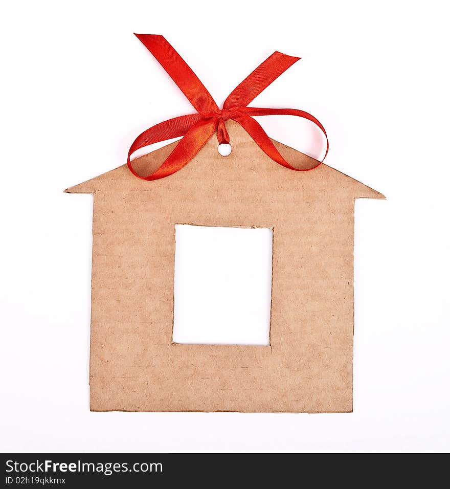 Cardboard house with red ribbon and bow