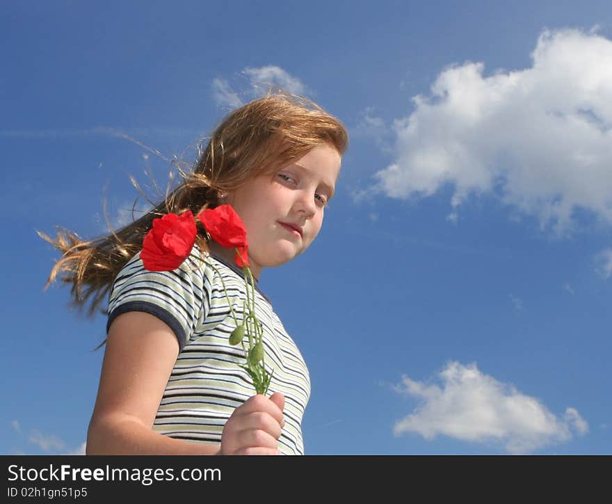 Girl with poppies over sky