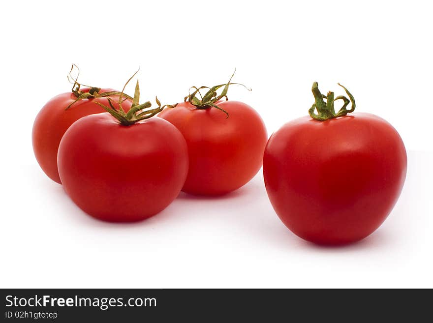 Four red tomatoes isolated on white. Four red tomatoes isolated on white