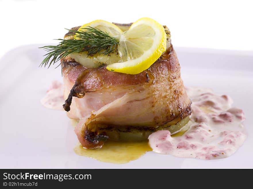 Meat with lemon and dill on white plate. close up