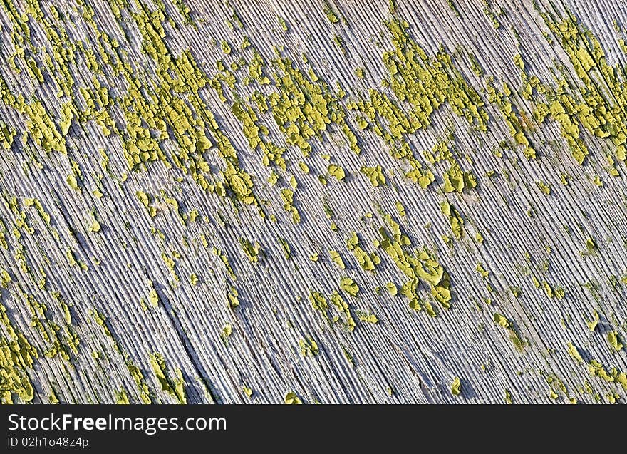 Old wooden board with flaked green paint