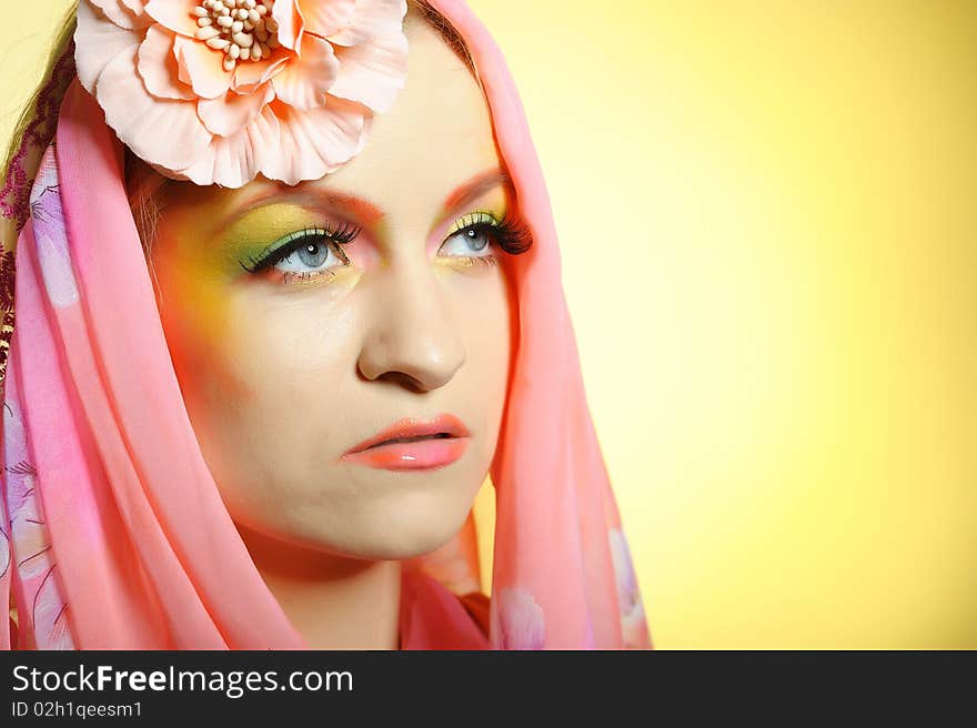 Close-up portrait of summer fashion creative eye make-up in yellow and green tones. Close-up portrait of summer fashion creative eye make-up in yellow and green tones