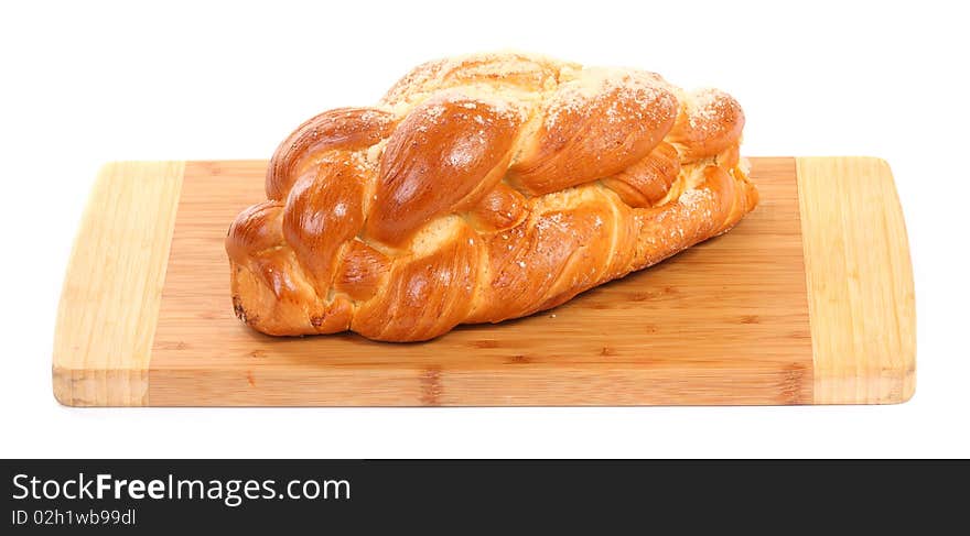 Poppy seed roll isolated on wooden board