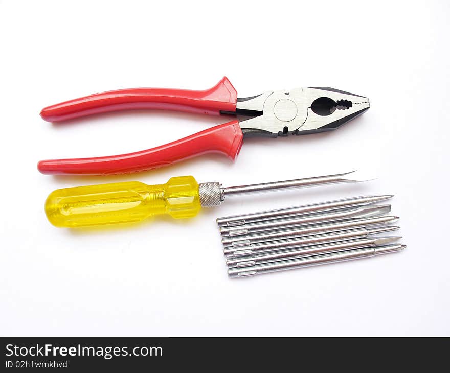 Red plier and yellow screw driver set isolated on white. Red plier and yellow screw driver set isolated on white.