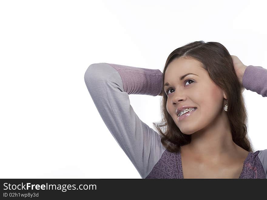 Smiling young girl wearing bracket system looking up with happy expression isolated over white background. Smiling young girl wearing bracket system looking up with happy expression isolated over white background