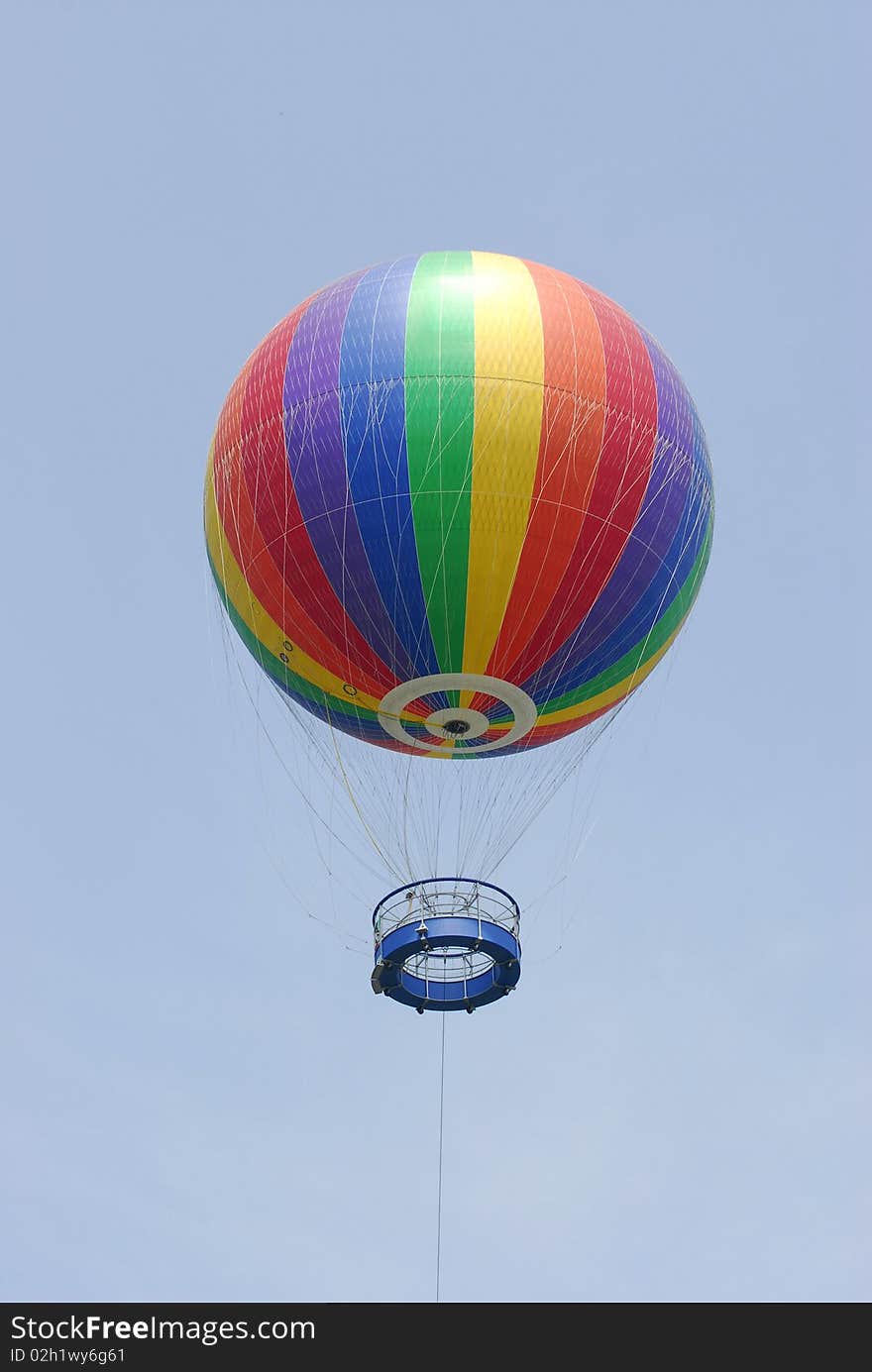 A colorful hot air balloon raise on air.