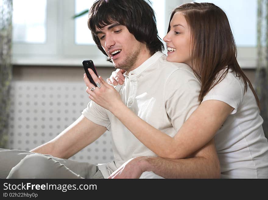 Boy with smile and nice girl with phone. Boy with smile and nice girl with phone