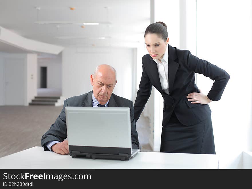 Two business people working on a laptop. Two business people working on a laptop