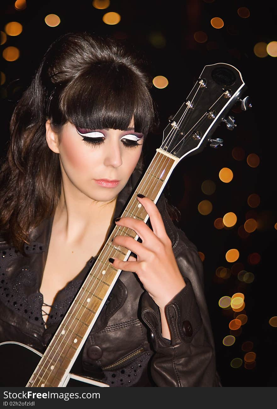 The young girl with a guitar on a roof of a high-rise building. The young girl with a guitar on a roof of a high-rise building