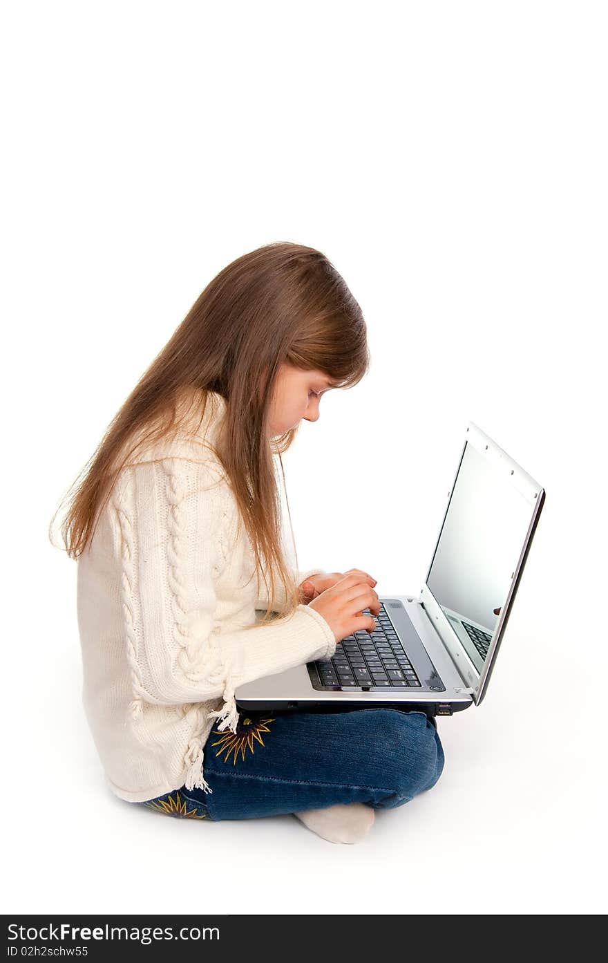 The sitting little girl with the laptop on white