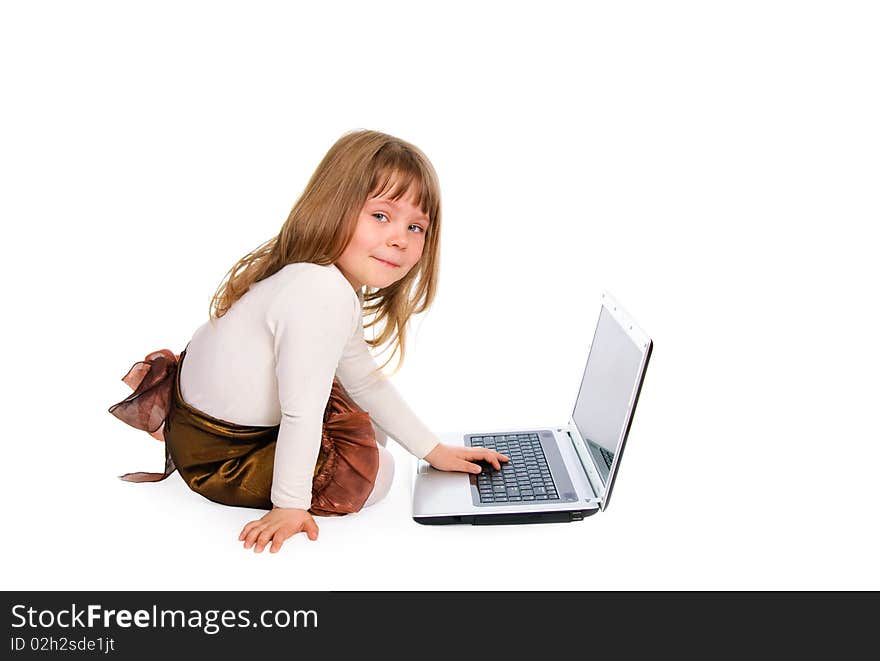 The sitting little girl with the laptop on white