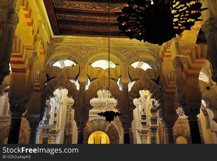 Cordoba's Mezquita is a Blend of Moorish and Christian Architecture.Sunlight streams in from windows in the four cupolas creating interesting effects combined with artificial light from the thousands of small oil lights. Cordoba's Mezquita is a Blend of Moorish and Christian Architecture.Sunlight streams in from windows in the four cupolas creating interesting effects combined with artificial light from the thousands of small oil lights.