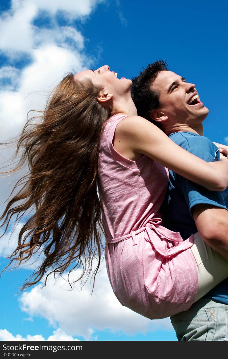 Young couple against the sky