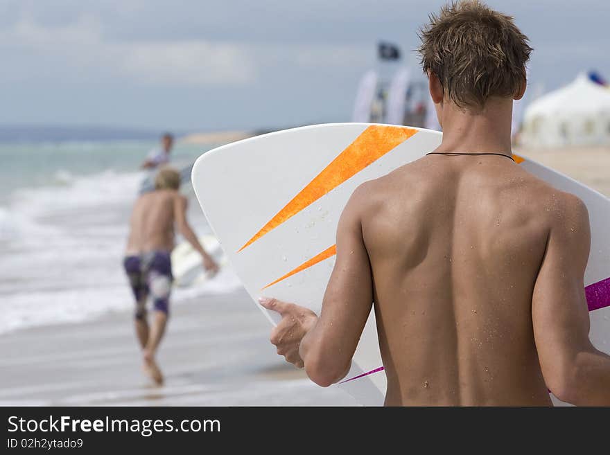 Two yong surfer riding on coastal waves