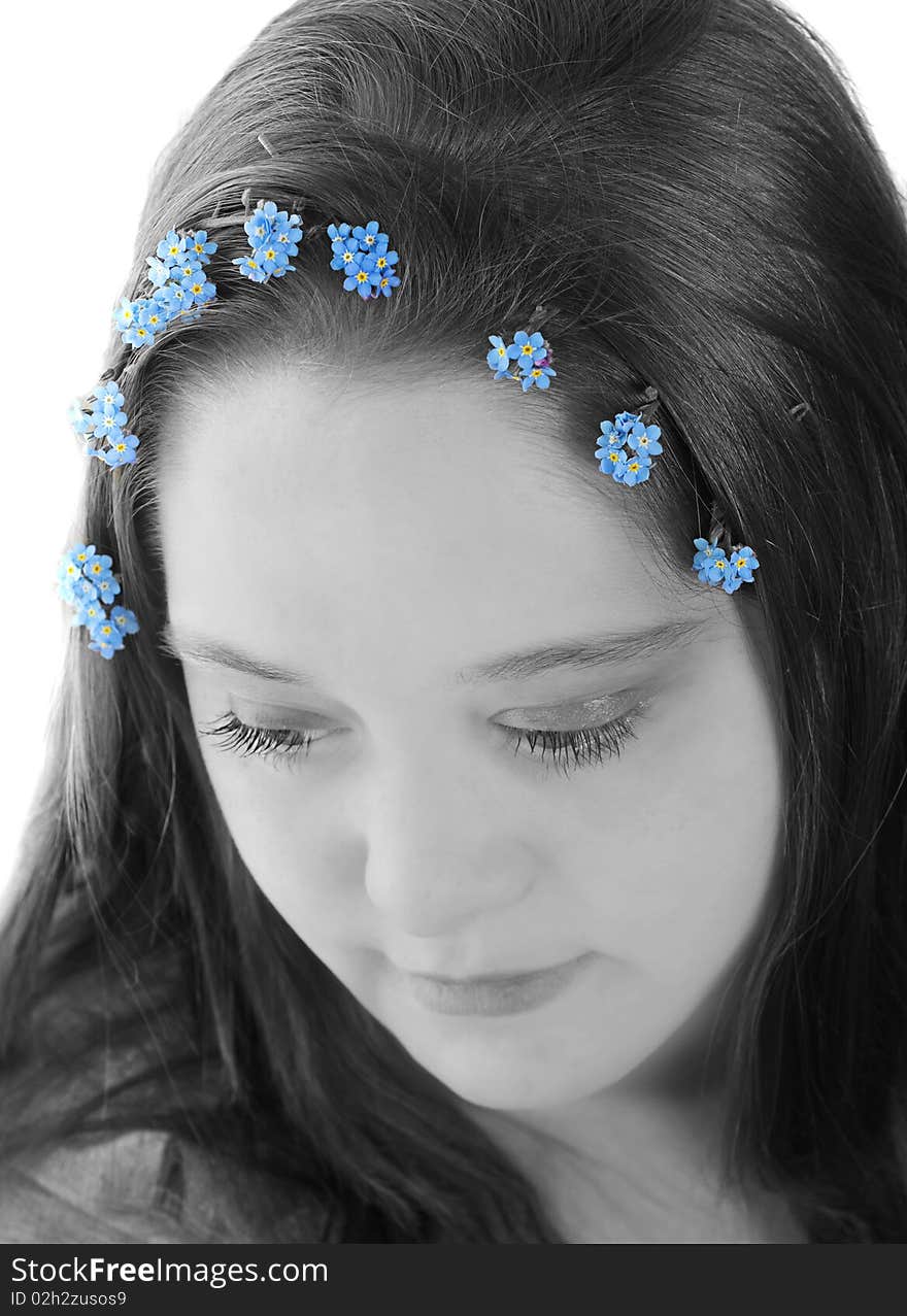 Portrait of young woman with forget-me-not flowers in her hair, selective color isolation. Portrait of young woman with forget-me-not flowers in her hair, selective color isolation.