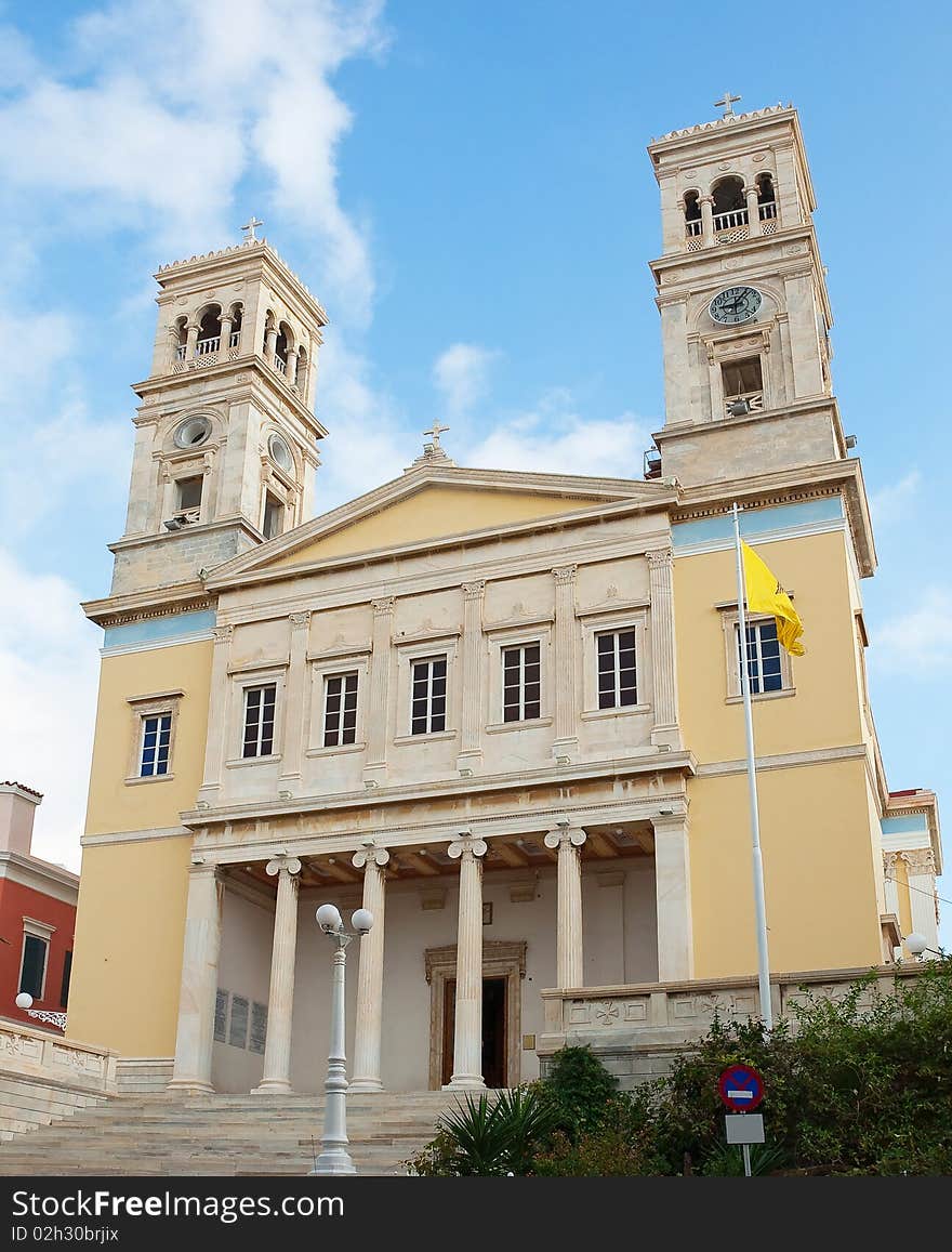 The Greek Orthodox church with two towers on the island of Syros against the blue sky. The Greek Orthodox church with two towers on the island of Syros against the blue sky