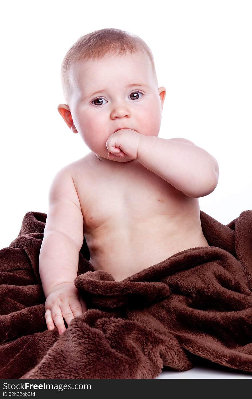 A beautiful baby with brown towel on white