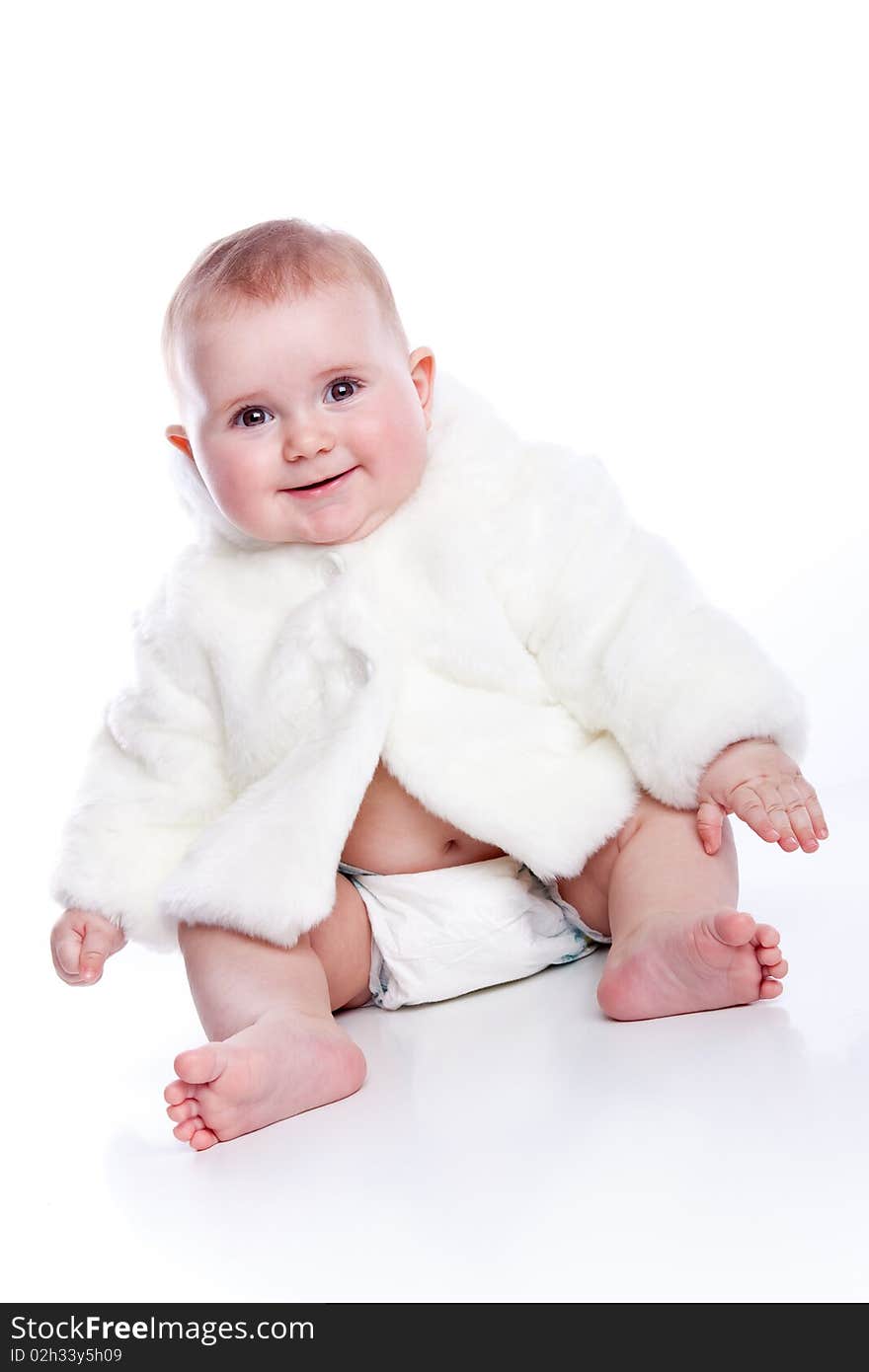 Cute little girl with a warm coat on white background