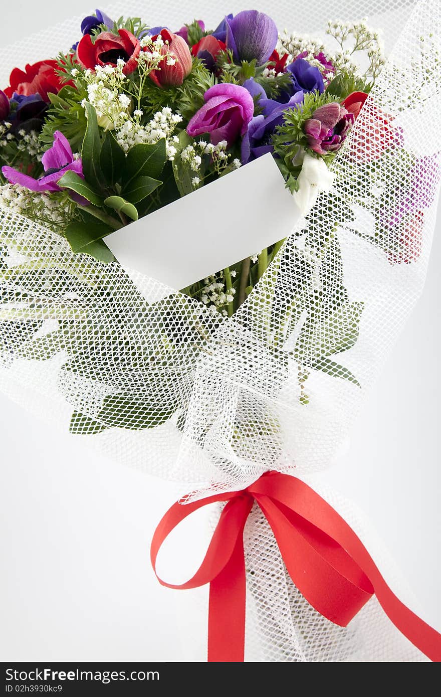 Bouquet of flowers with blank white card