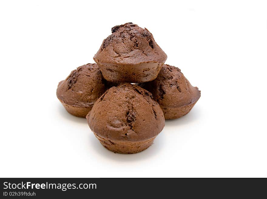 Pile of chocolate muffins isolated on white.