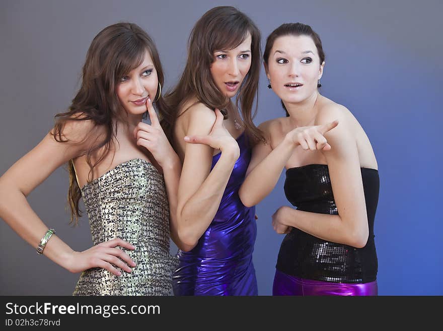 Three female friends discussing - shot in a studio. Three female friends discussing - shot in a studio