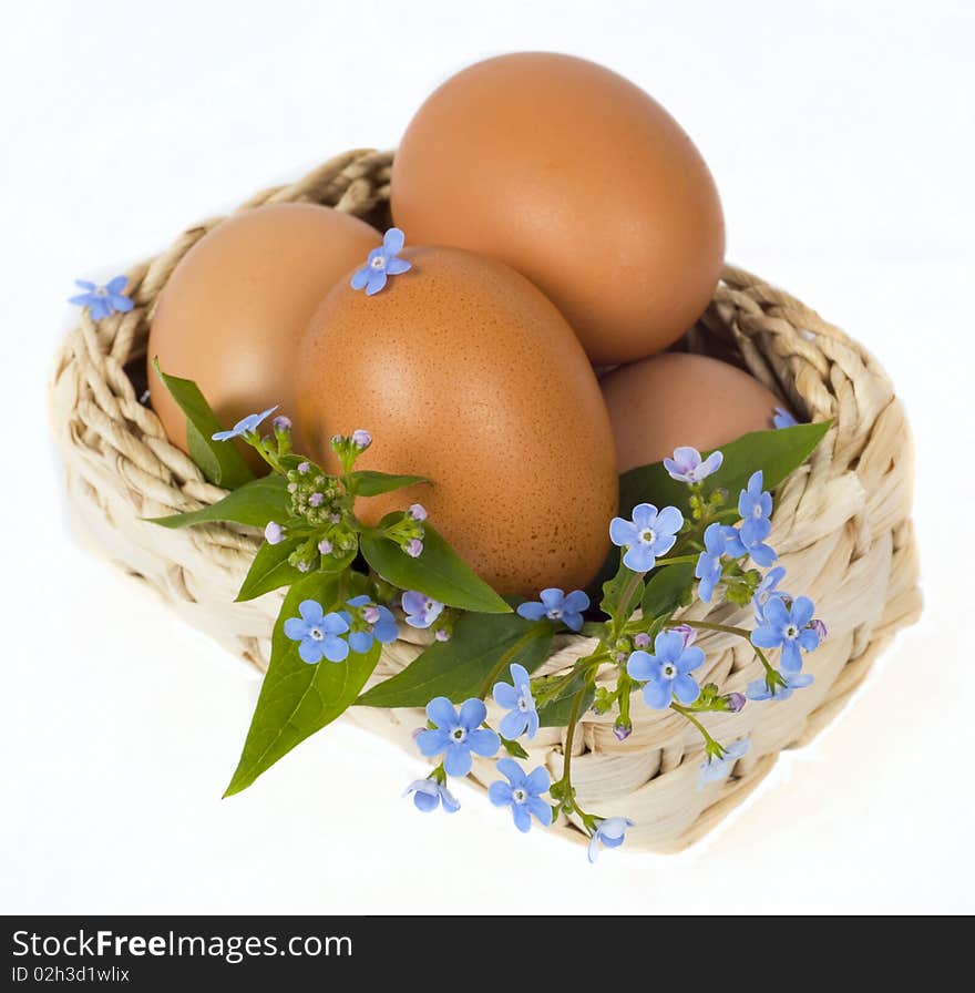 Colour eggs in basket are isolated on white background