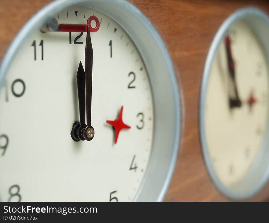 Old chess clock with showing the final moments before the red flag goes down, may suggest deadline,anticipation,tension, closeup shot with shallow DOF. Old chess clock with showing the final moments before the red flag goes down, may suggest deadline,anticipation,tension, closeup shot with shallow DOF