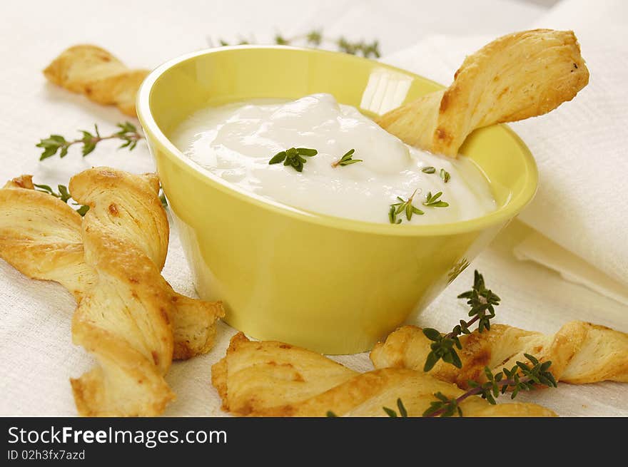 Cheese sticks served with white yogurt and fresh thyme