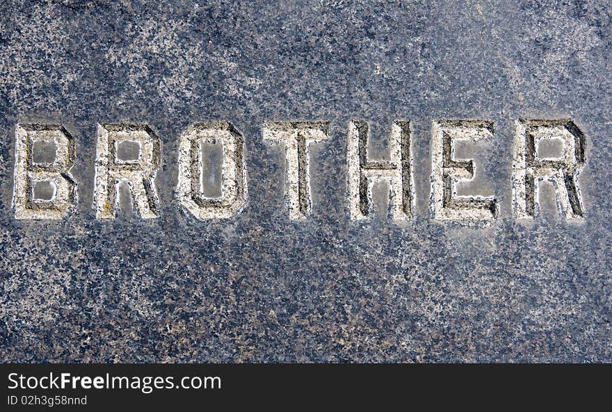 Brother inscription on old grunge granite tombstone.