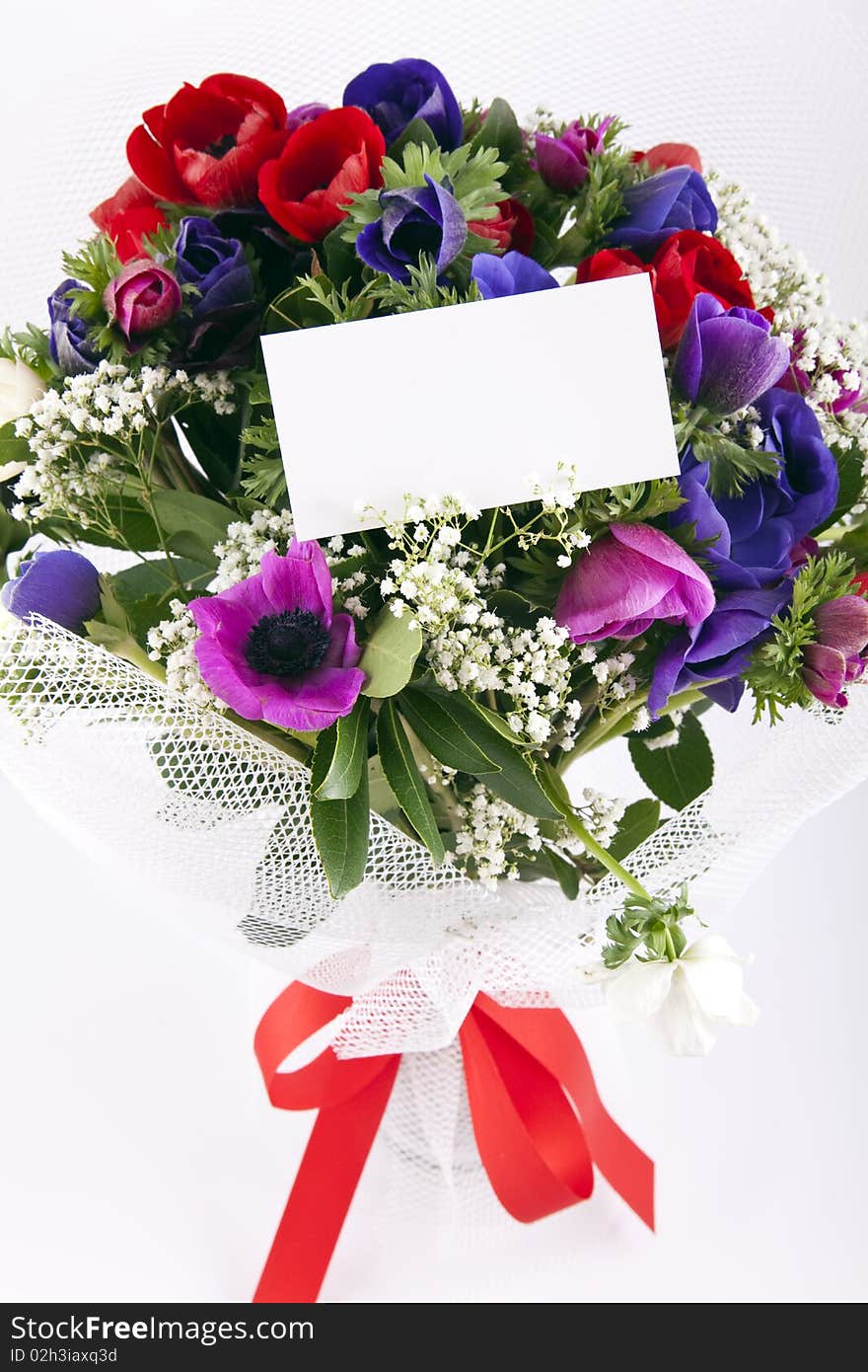 Bouquet of flowers with blank white card