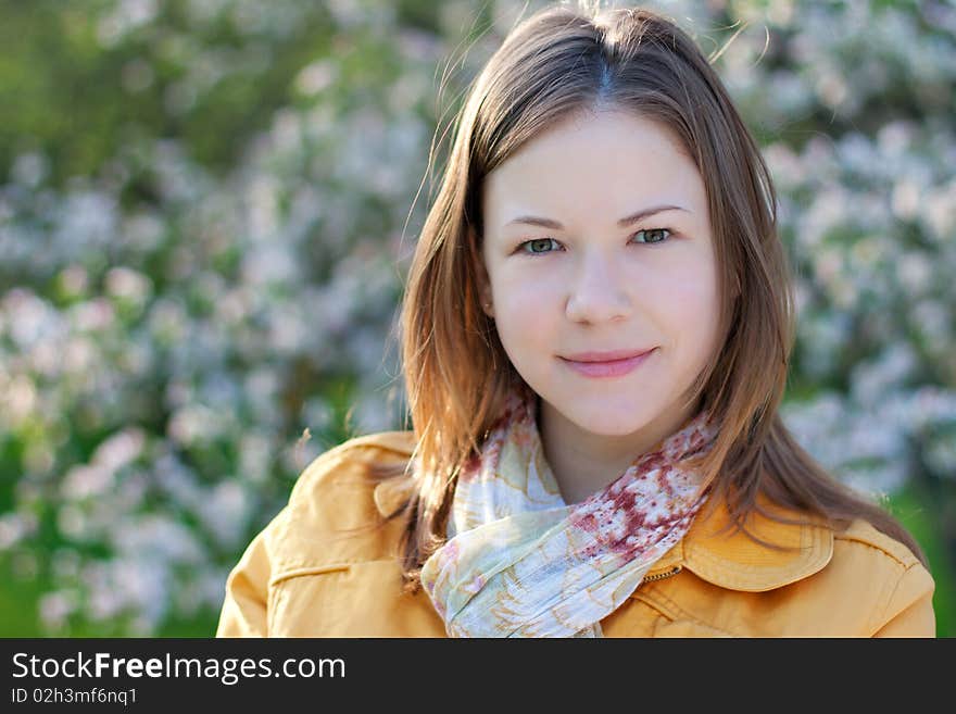 Young woman posing with a blooming branch in a spring park. Young woman posing with a blooming branch in a spring park