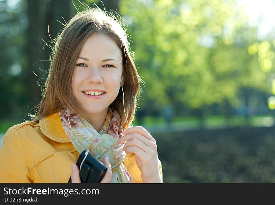 Young woman walking and listnening music. Young woman walking and listnening music