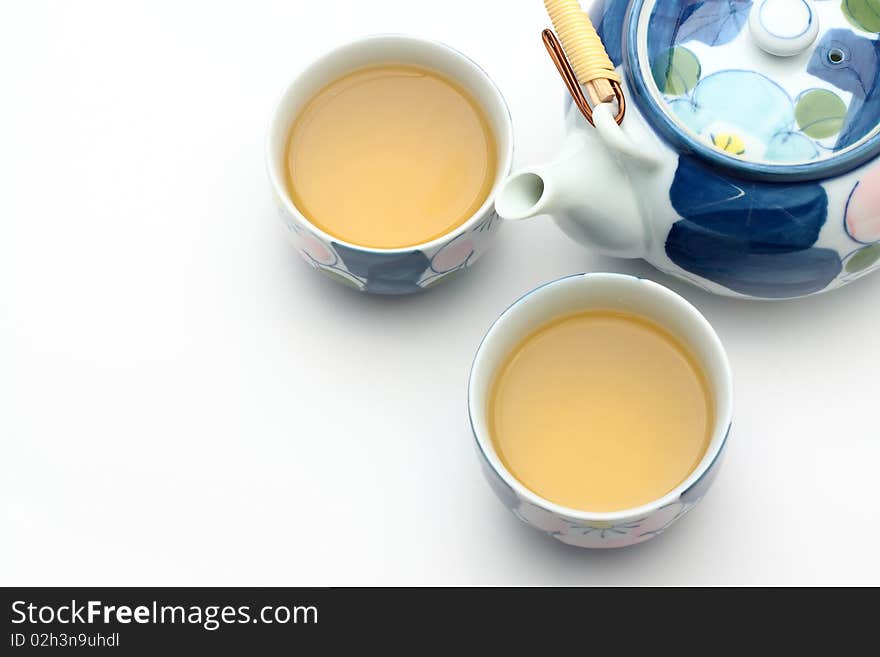 Decorative teapot and two cups of tea