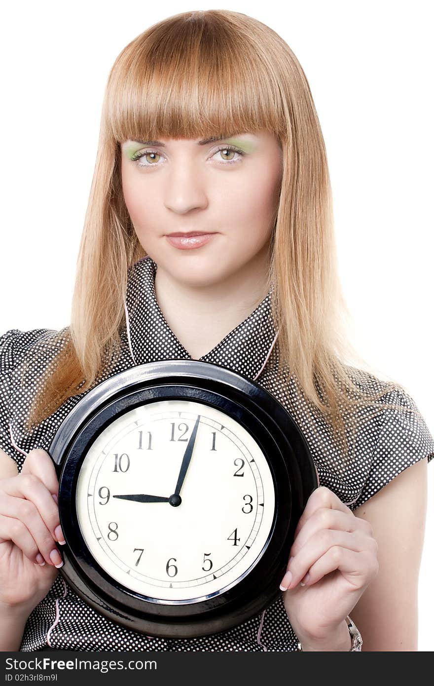 Beautiful young girl holding clock. Ower white