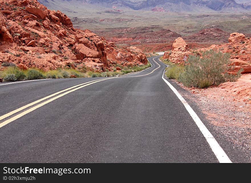 A lonely stretch of highway winding through the desert. A lonely stretch of highway winding through the desert